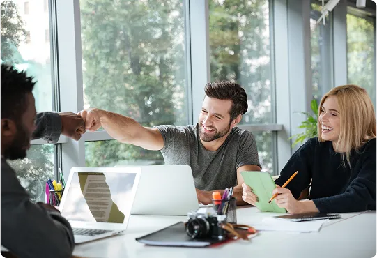 smiling colleagues sitting in office